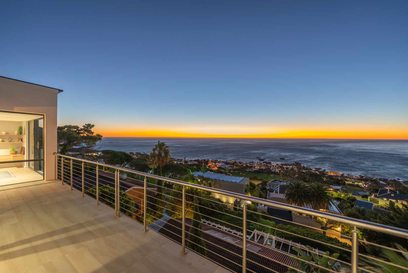 Camps Bay balcony view at sunset over the Atlantic